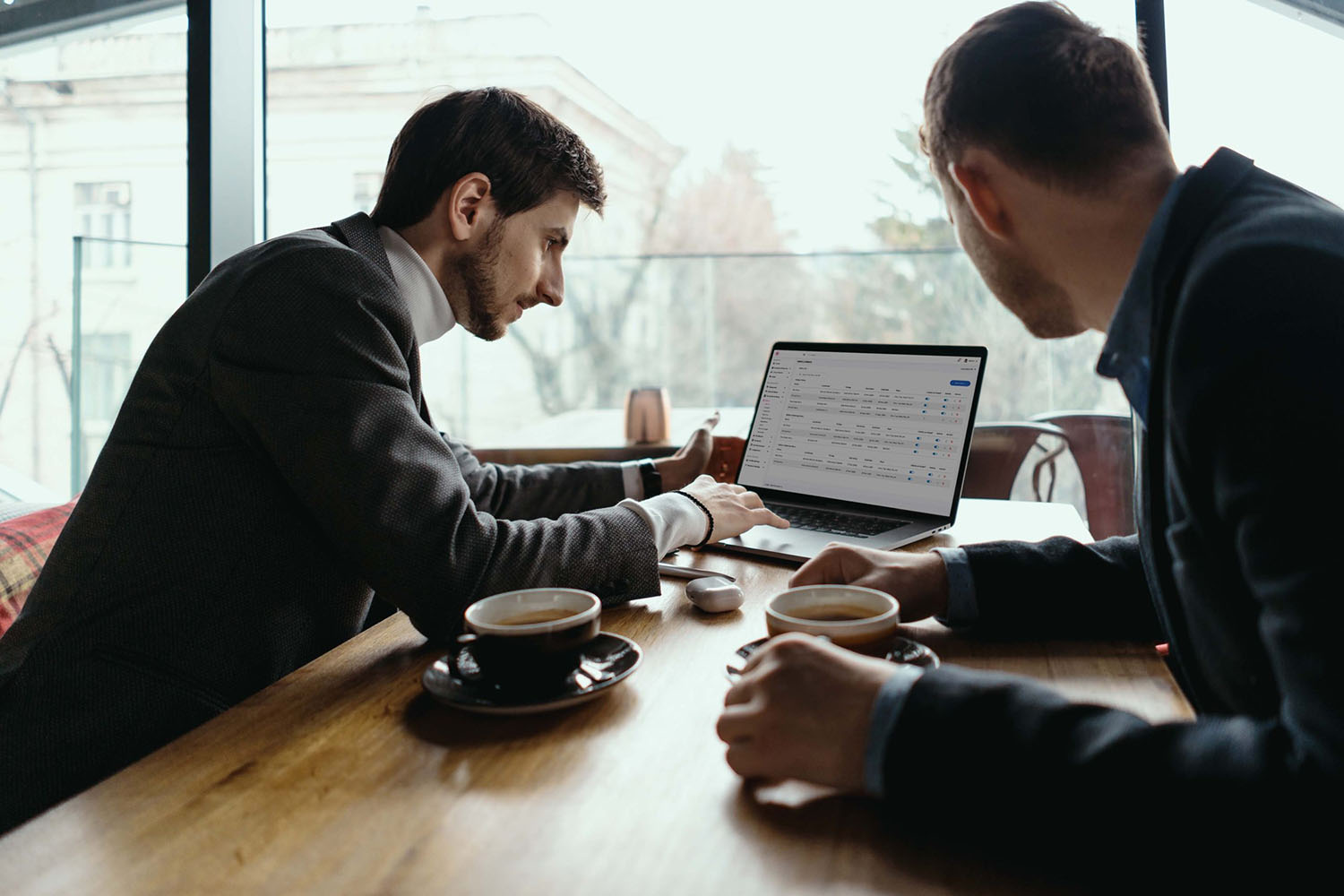 Two restaurant operators reviewing eatOS on a laptop