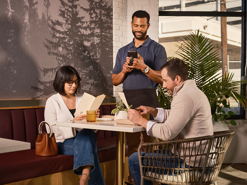 Manager updating a live menu on a tablet