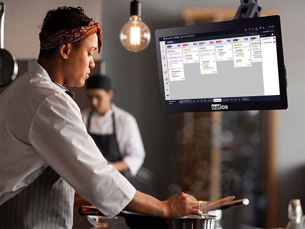 Chef reading order tickets on a kitchen display