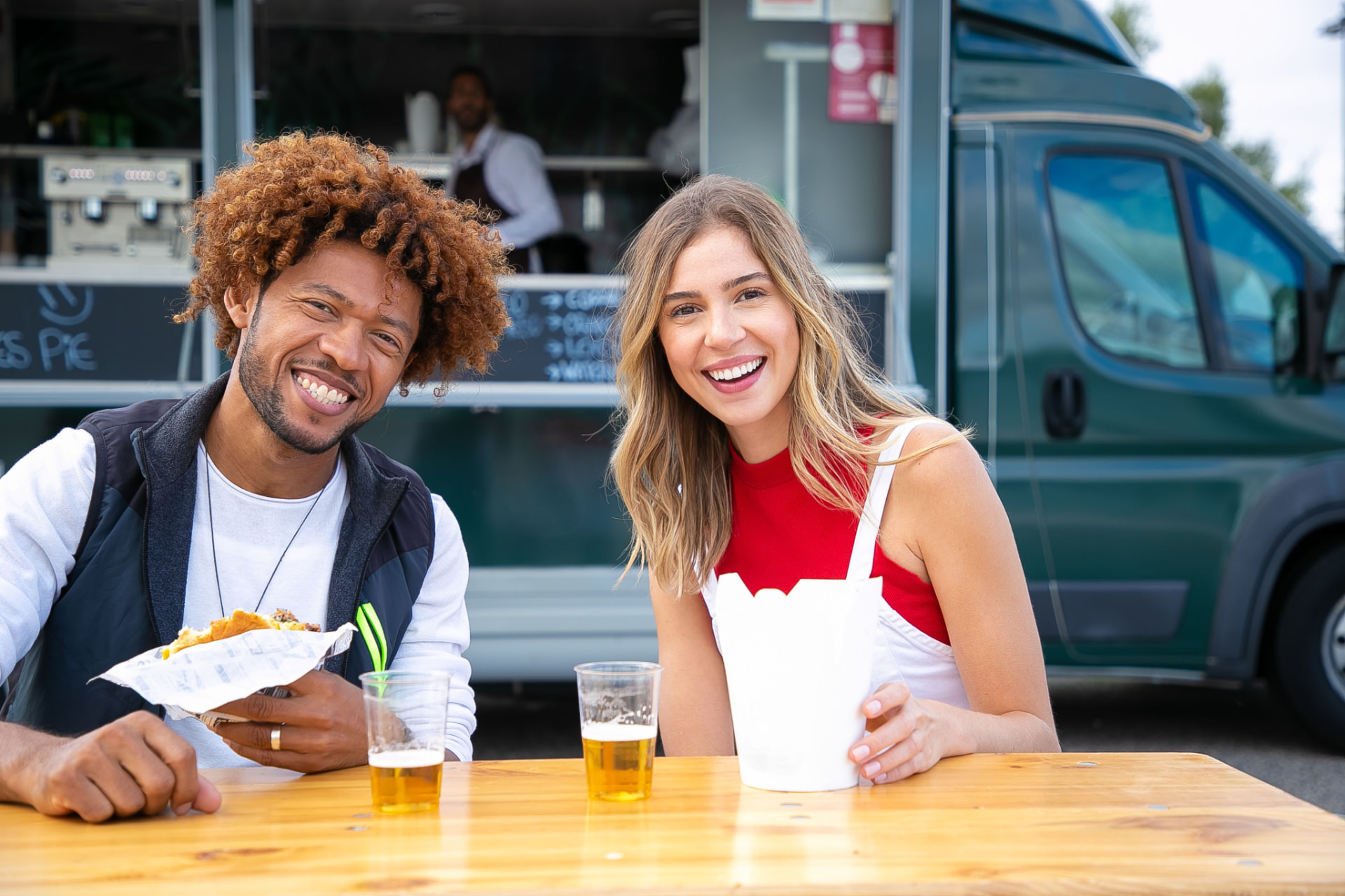 Guest tapping a phone to pay at a food truck counter
