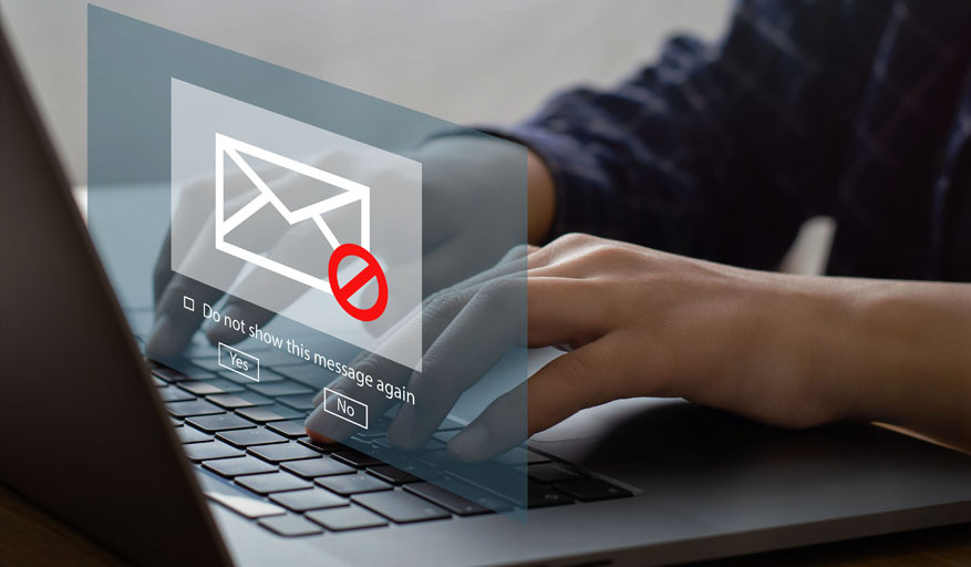 Blocked email warning over a laptop keyboard