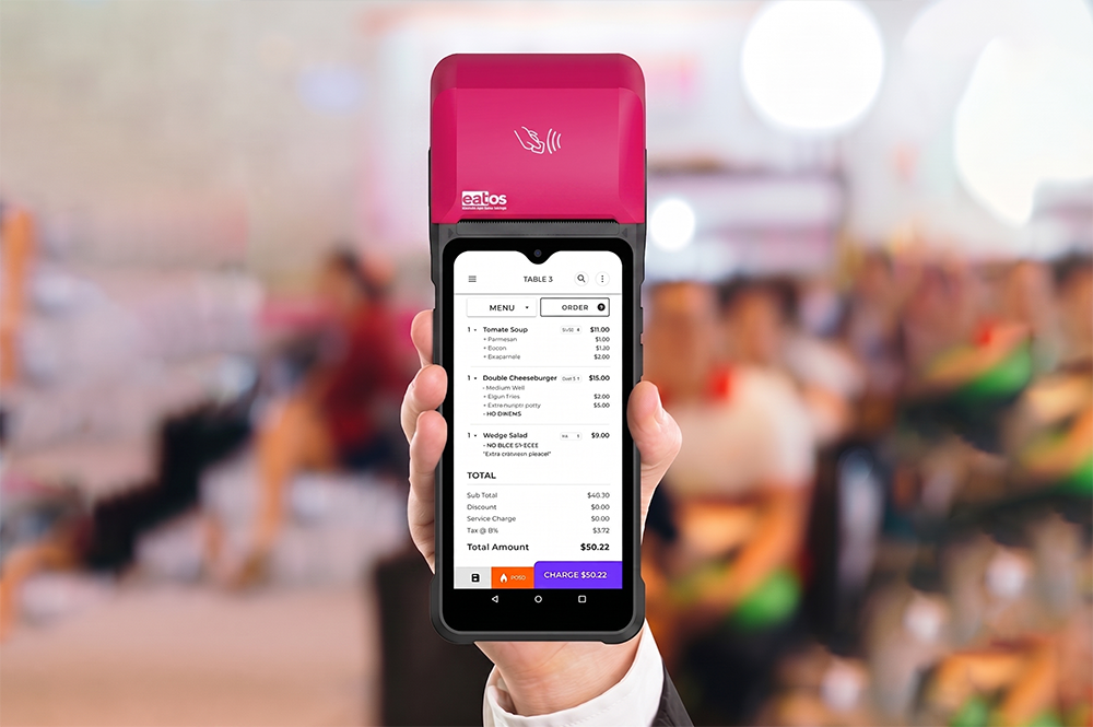 Handheld eatOS terminal in use at the counter